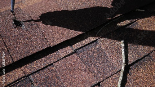 Man Attempts to use Tar Caulk to fill hole on Roof.