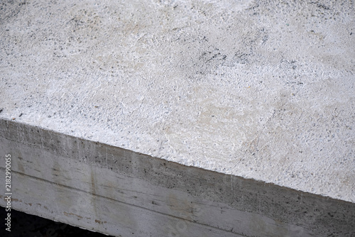 Layer of concrete slab. Concrete edge revealing rough textured top surface and smooth formed sides. Useful for construction, architecture, civil engineering, and industrial design backgrounds.