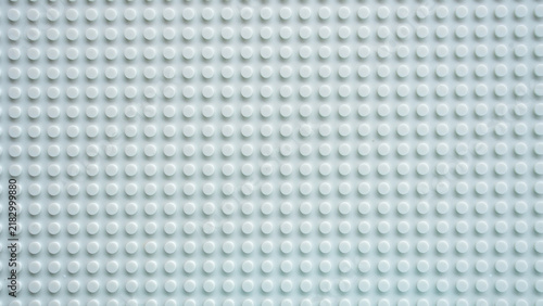 White plastic building brick baseplate texture with raised round studs pattern background