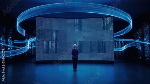 Specialist working a suspended holographic panel at a data wall