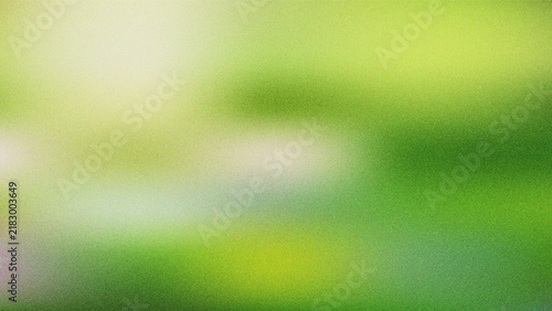 A soft focus abstract background features varying shades of vibrant green and yellowgreen hues creating a natural ethereal atmosphere