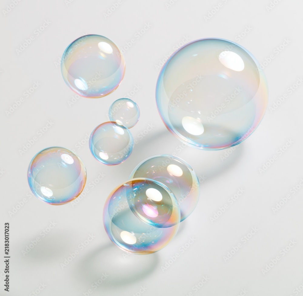 Obraz premium Colorful soap bubbles floating against white background