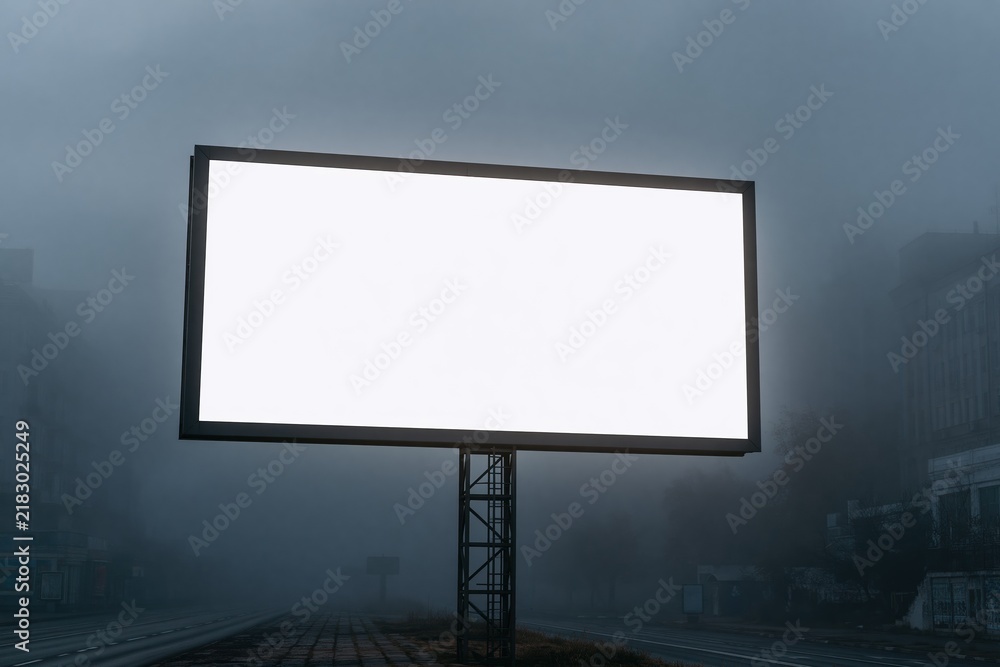 Obraz premium Blank billboard standing alone in foggy urban street