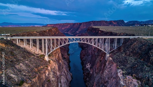 Highway bridge over deep canyon landscape.