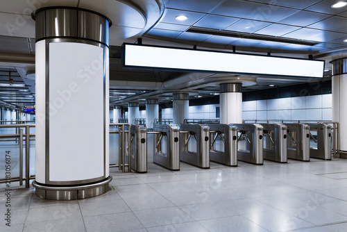 Blank white column wrap and horizontal light box above ticket gates in a train station