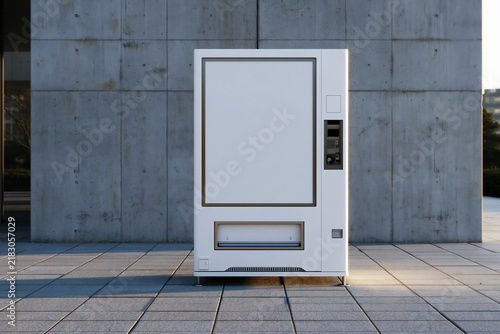Blank white vending machine front panel against a concrete wall