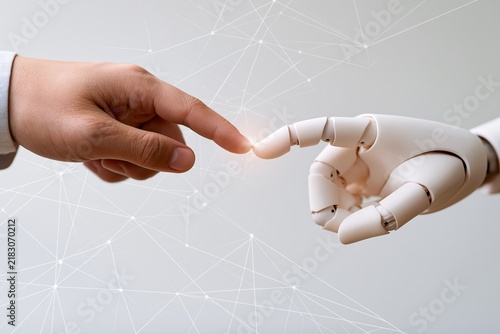 Human hand touching robotic finger with digital network