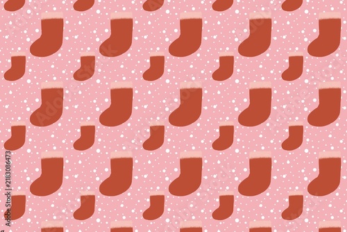 Repeated pattern of small red christmas stockings on a soft pink background