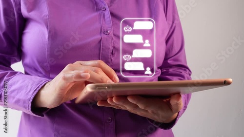A woman holds a tablet displaying a chat interface with a bot. Professional technology or communication theme.