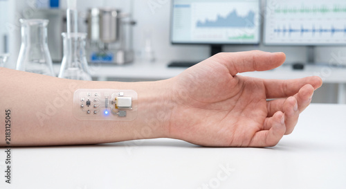 Adhesive Non-Invasive Biomedical Sensor Patch on Young Adult Hand in Laboratory