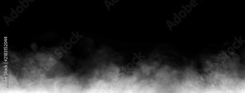 Abstract white smoke and ground fog layer isolated on black background. Cinematic low fog vapor overlay effect for atmospheric background texture and digital design assets.