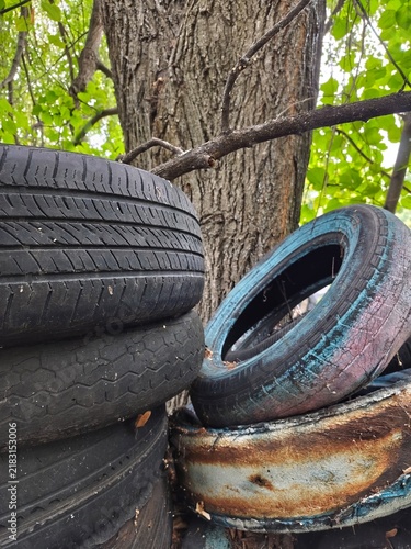 old, worn-out car tires in the forest
