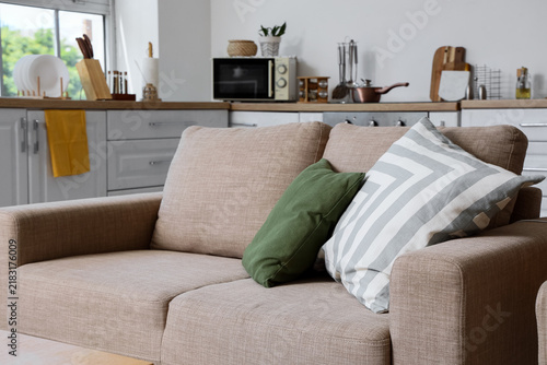Quadro su tela Home comfort and interior design, cozy beige sofa with decorative pillows in a m