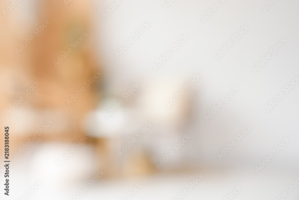 Obraz premium Blurred view of light room with armchairs, wooden folding screen and plants