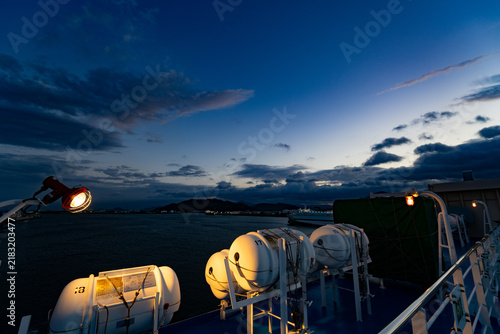 Фотография Passenger ferry deck and liferafts beneath a dramatic blue hour sky