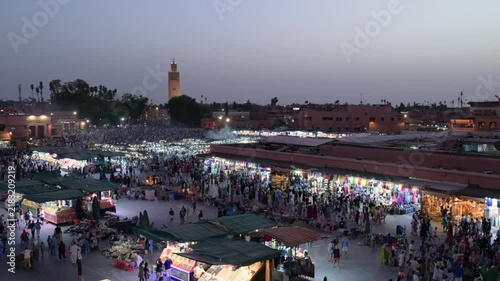 Marrakech, morocco. August 9, 2026. Bustling panoramic view of djemaa el fna square in marrakech, morocco. People crowding the famous night market with the koutoubia mosque in the background