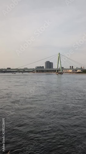 View of the river and bridge from the embankment in Cologne during late afternoon