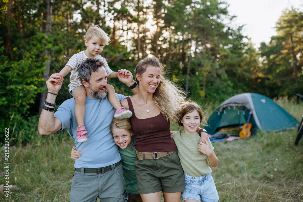 Obraz premium Happy family spending time together during summer camping trip.