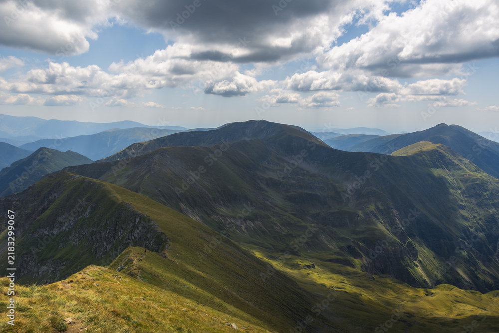 Fototapeta premium Massive rounded mountain peak under a dramatic cloudy sky