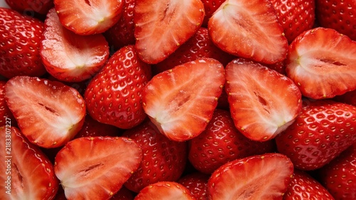 Fresh sliced ripe red strawberries flat lay background texture
