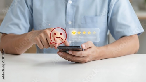 Person leaving negative feedback or a poor review on a smartphone with a sad face emoji and one-star rating, reflecting customer dissatisfaction and a bad service experience online
