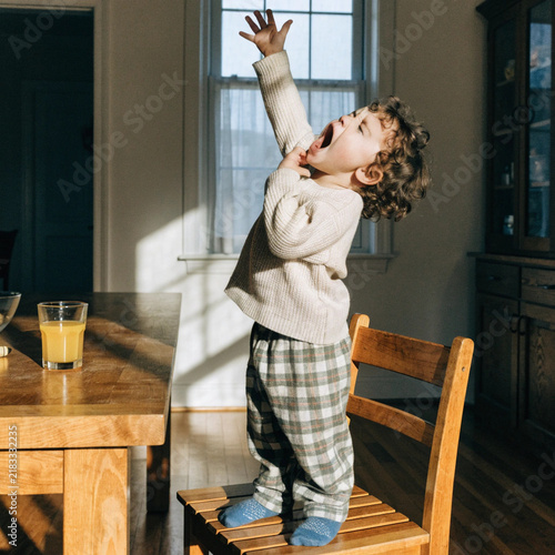 Toddler Yawning and Stretching in Bed During Morning