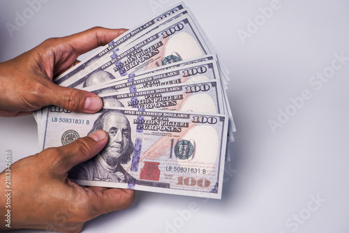 Принти на полотні A wad of US$100 bills is being held by someone.