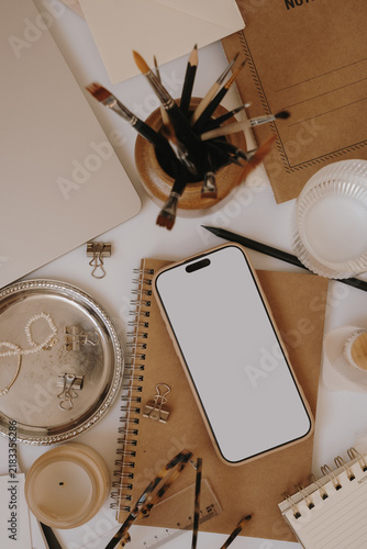 Flat Lay Composition Of Creative Desk Essentials With Blank Mobile Screen Mockup And Kraft Notebooks