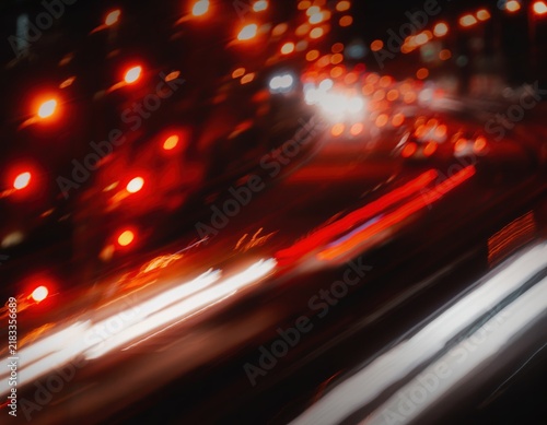 Abstract long exposure light trails of traffic on a city street at night