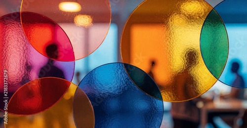 Abstract Colorful Circles on Glass Window with Blurred People Silhouette