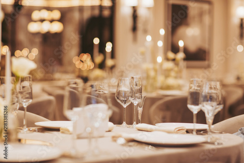 Elegant dining setup in a luxurious restaurant with soft candlelight and sophisticated table setting