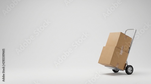 Two cardboard boxes stacked on a metal hand truck against a plain white background with brown cardboard moving