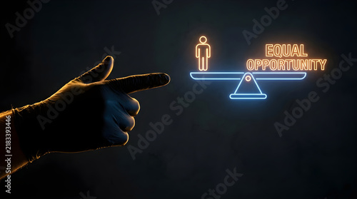 Gloved hand pointing at a neon balance scale symbol with equal opportunity text on dark background