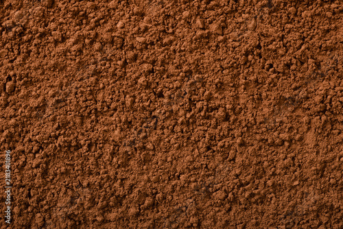 Food background of raw cocoa powder, top view.