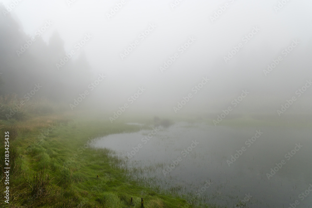 Obraz premium Misty fog over mountain lake water in taiwan