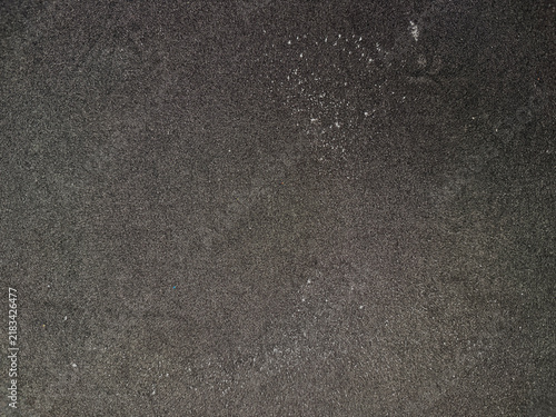 Fotografie Closeup of white lint and dust particles on dark grey fabric texture