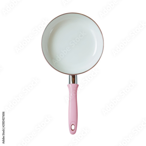 A white frying pan with a pink handle sits on a flat surface in a kitchen setting