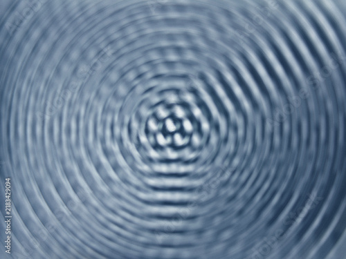 Abstract blue water ripples creating concentric circular wave patterns