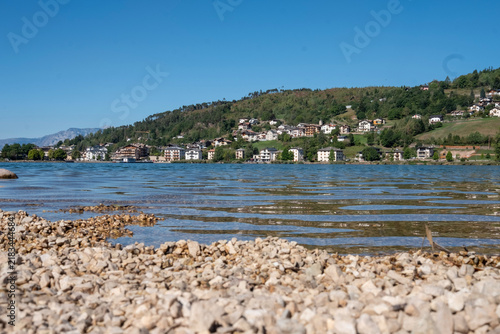 Bild auf Leinwand Panorama of Lake Serraia, in Trentino, overlooking the body of water and the sur