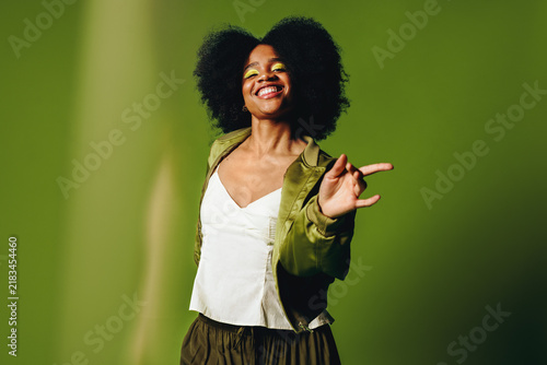 Dancing woman brings joyful lifestyle energy to a confident studio portrait