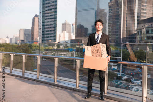 Fotografie Job Seeker Holding Sign on Rooftop