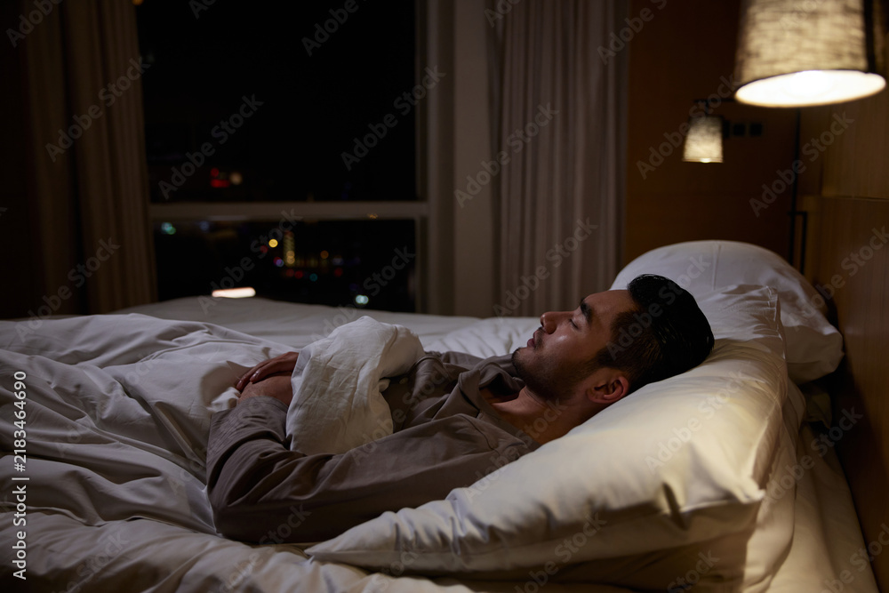 Fototapeta premium Man Resting in Bed at Night