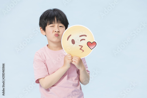 Fotografie Boy Puckering Lips with Kiss Emoji Sign