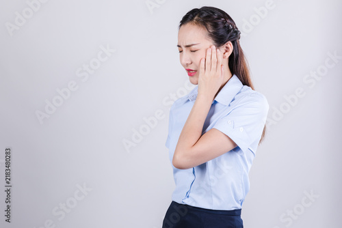 Foto Businesswoman in pain holding cheek