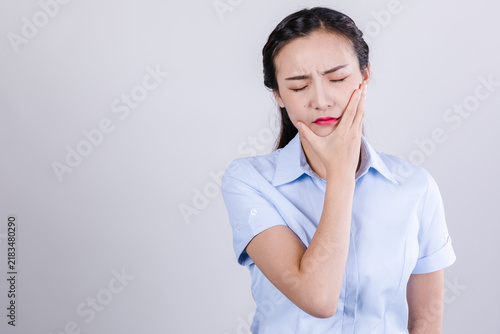 фотографія Painful businesswoman holding cheek in distress