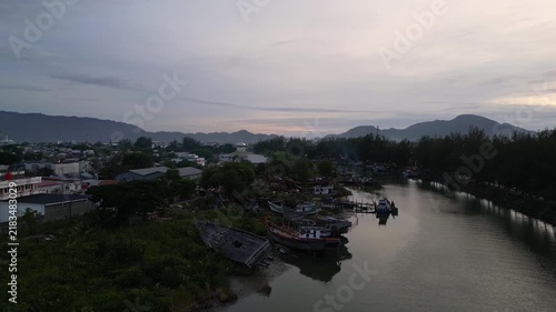 Banda Aceh, Indonesia : Aerial drone footage above the river in Banda Aceh of Sumatra, Indonesia. Taken with upward and tilt down motion revealing the crowded city at sunset