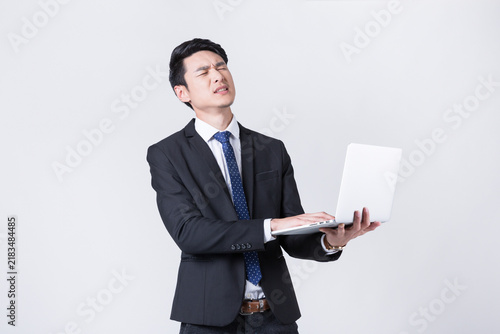 Foto Businessman Straining at Laptop Under Pressure