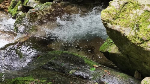 Close up of white water splashing over rocks at Hossawa Falls Japan