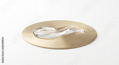 Side view of clear peptide gel wave gliding over brushed brass disc on white background