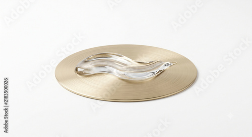 Side view of clear peptide gel wave gliding over brushed brass disc on white background